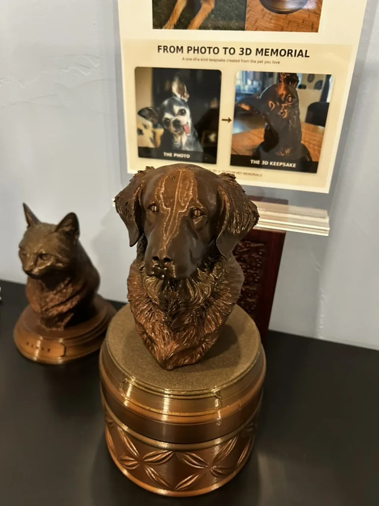 A custom 3D bust of a dog on a bronze-tone urn